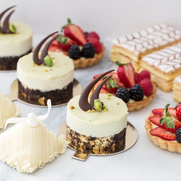 Assortment of Honeymoon Sweets European Bakery pastries, including cakes, tarts, and mille-feuille.